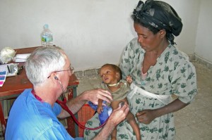 Phil Stillman with baby in Ethiopia